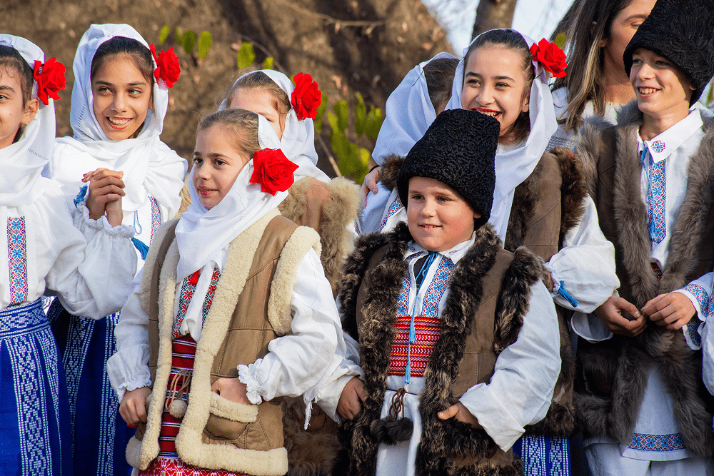 Children dressed in traditional costumes caroling